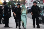 police-arrest-protestor-dressed-statue-124639285.webp